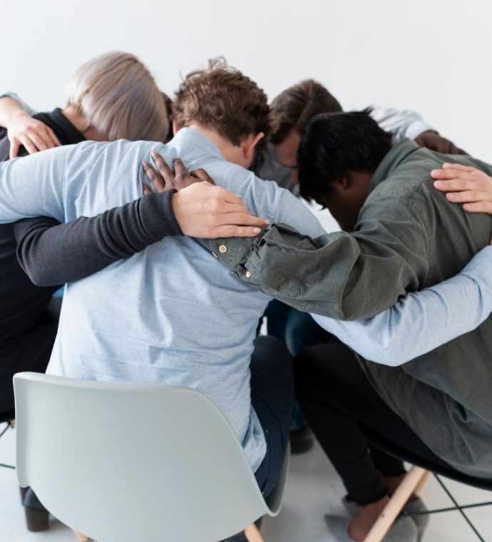 people-standing-chairs-embracing